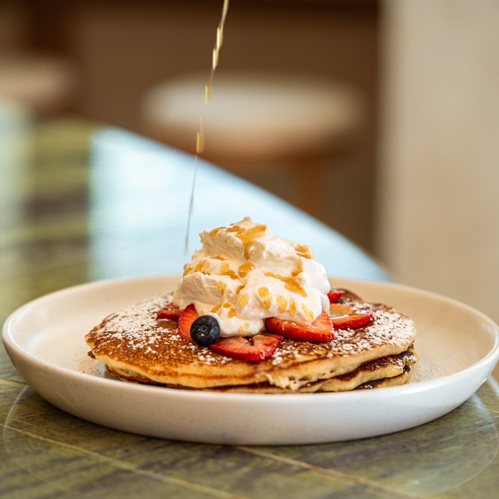 Buttermilk pancake stack with fresh berries at Café Maud