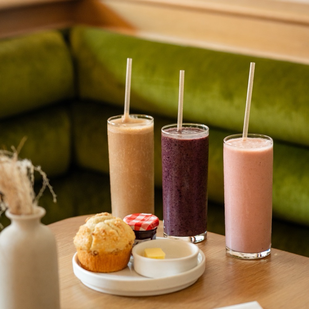 Strawberry, blueberry, and PB&J smoothies with a fresh muffin at Café Maud